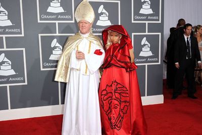 While most people bring their partners/puppies/pot plants to the Grammys, Nicki decided to bring the "pope" to the music awards.<br/><br/>Not to be outdone by the holy one, the controversial rapper lost herself in layers and layers of Versace-embellished silk, complete with a cape-cloak.