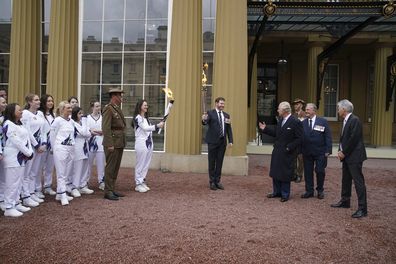 King Charles III, third right, attends the start of the Australian Legacy Torch Relay to mark the beginning of the London-leg of the charity's relay race in celebration of their centenary year at Buckingham Palace in London, Friday April 28, 2023.  