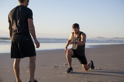 Chris Hemsworth working out with Luke Zocchi on a beach