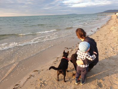 Chris with his son Oscar and dog on the beach