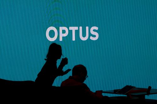Customers wait to be served inside an Optus store