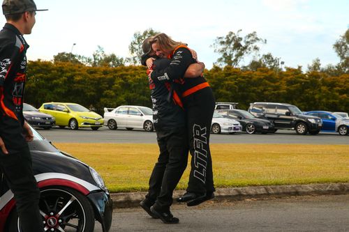 Kelly hugs her team owner Phil Lamattina after leaping from the cabin. Picture: Drag Photos