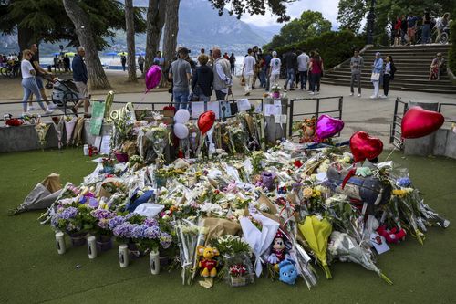 Flowers are laid down at a children's playground in Annecy, France, Saturday, June 10, 2023 following a knife attack on Thursday, June 8, 2023.  