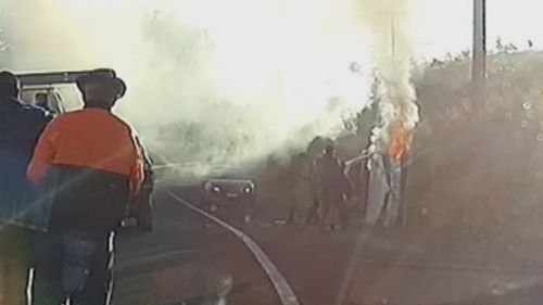 Officers can be seen using their batons to smash through the windscreen. Picture: Supplied