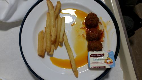An odd combination of meatballs, chips, and tartare sauce.