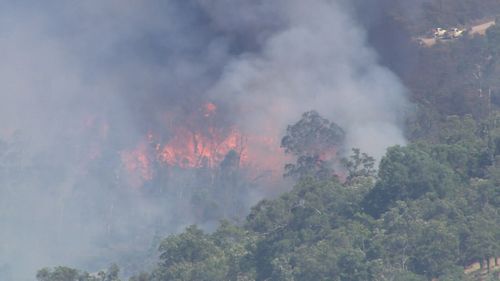 A major bushfire is threatening homes in Perth's north-east.