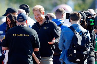 THE HAGUE, NETHERLANDS - APRIL 17: (EMBARGOED FOR PUBLICATION IN UK NEWSPAPERS UNTIL 24 HOURS AFTER CREATE DATE AND TIME) Meghan, Duchess of Sussex and Prince Harry, Duke of Sussex (accompanied by a film crew) meet athletes and their supporters at the athletics competition on day 2 of the Invictus Games 2020 at Zuiderpark on April 17, 2022 in The Hague, Netherlands. (Photo by Max Mumby/Indigo/Getty Images)