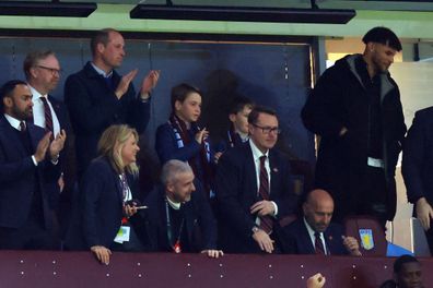  Prince William, Prince of Wales and Prince George of Wales look on alongside Tyrone Mings of Aston Villa