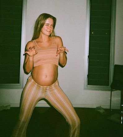 Steph Claire Smith poses in a two-piece set while pregnant.