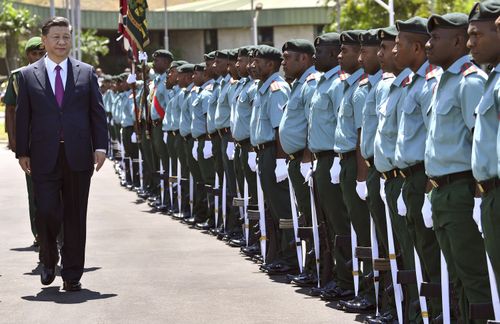 China's President Xi Jinping inspects the guard of honour at Parliament House in Port Moresby ahead of the Asia-Pacific Economic Cooperation (APEC) Summit. 
