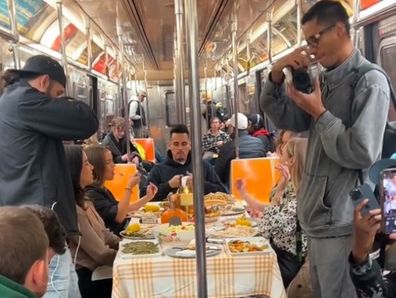 Group of friends having Thanksgiving dinner on the subway