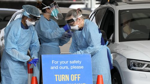 Staff prepare to collect samples at a drive-through COVID-19 testing clinic in Bondi Beach in Sydney, Australia.