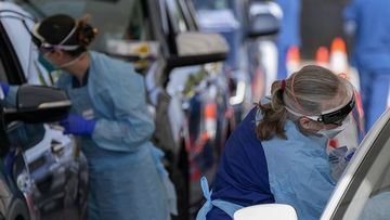 Staff collect samples at a drive-through COVID-19 testing clinic at Bondi Beach.