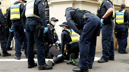 A protester is arrested in Melbourne.
