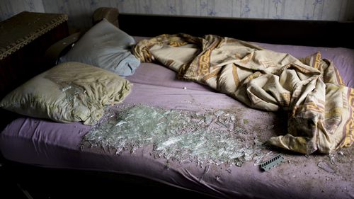 Shattered glass lies on the bed at a house damaged after a strike in Druzhkivka, Ukraine, Sunday, June 5, 2022. (AP Photo/Bernat Armangue)