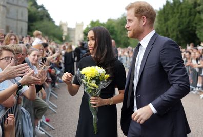 Harry and Meghan with crowd outside Buckingham Palace