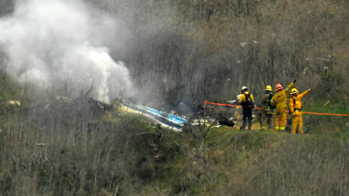 Firefighters work the scene of a helicopter crash where former NBA basketball star Kobe Bryant died in Calabasas, California Jan. 26, 2020. (AP Photo/Mark J. Terrill, File)