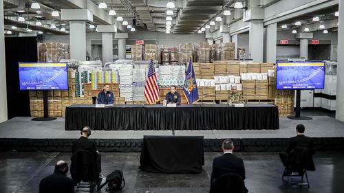 Gov. Andrew Cuomo speaks while practicing social distancing against a backdrop of medical supplies during a news conference at the Jacob Javits Center that will house a temporary hospital in response to the COVID-19 outbreak.