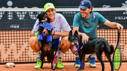 Tennis players Marcelo Demoliner and Joao Zwetsch kept the dogs busy. (Facebook / Brazil Open de Tenis)