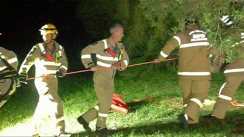 Emergency services set-up a rope system to winch the man to safety. 