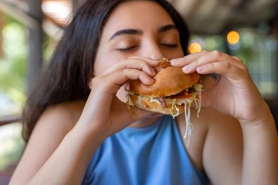 Woman eating hamburger