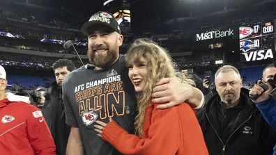 Kansas City Chiefs tight end Travis Kelce walks with Taylor Swift
