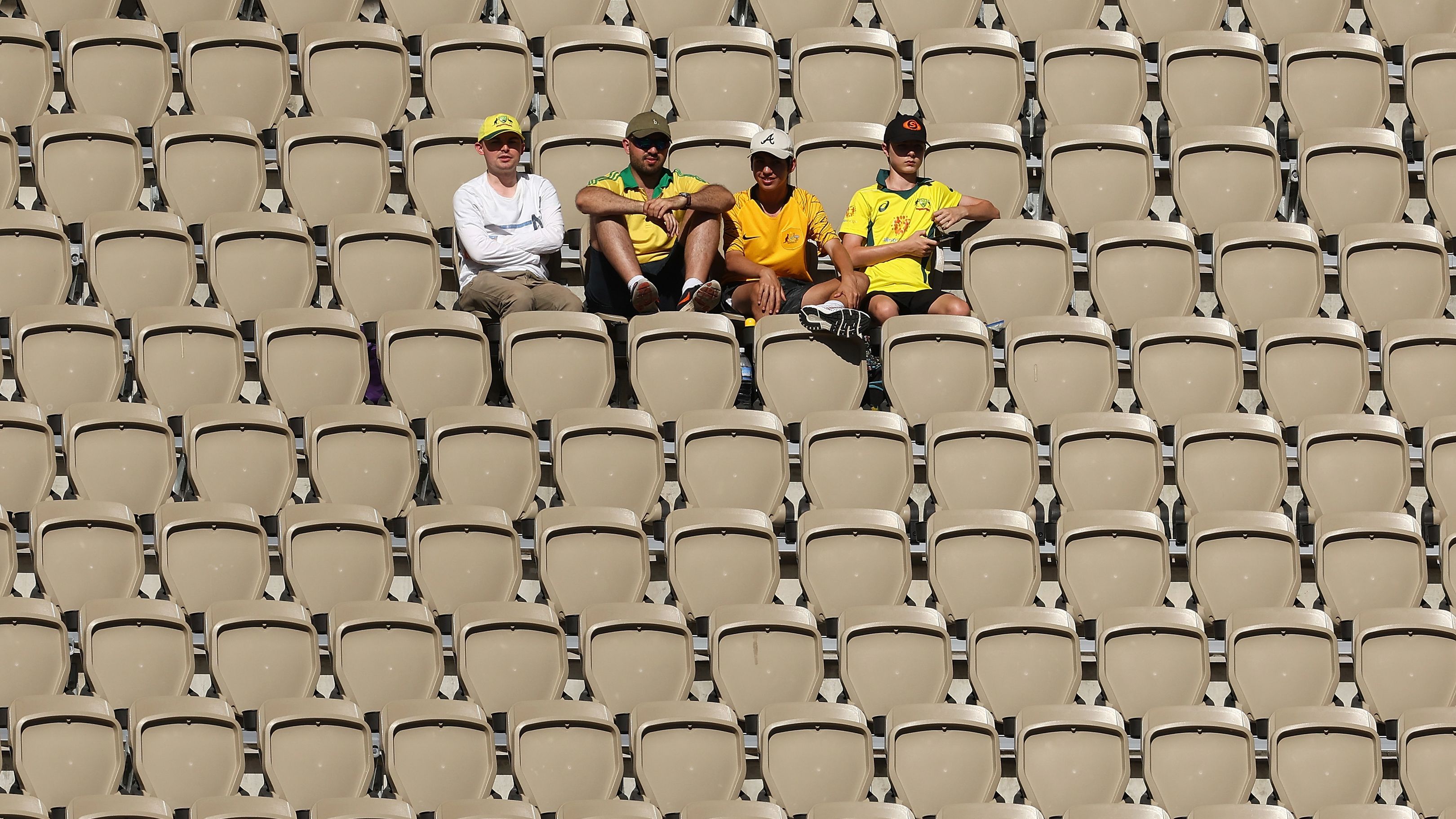 A handful of fans sit inside Perth Stadium on day four of the Test between Australia and Pakistan.