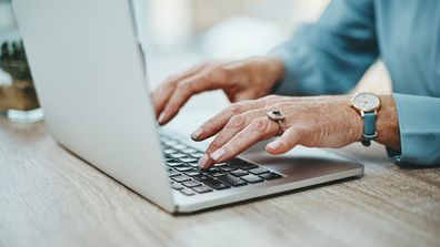 Laptop computer older woman old lady grandmother internet senior citizen hands typing