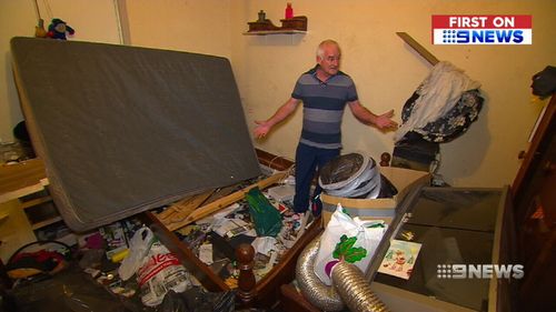 "I'm devastated": Colin Smith stands amid the rubbish in his investment home. (9NEWS)