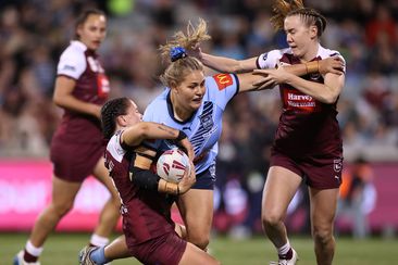 Caitlan Johnston of the Blues is tackled.