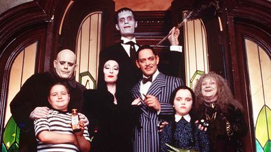 Family photo of The Addams Family (1991), featuring Raul Paul, Anjelica Huston, Christina Ricci, Jimmy Workman, Christopher Lloyd, Carel Struycken and Judith Maline.