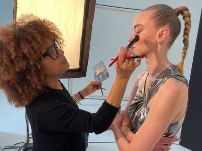 Smashbox Global Lead Pro Artist Lori Davis applies makeup to a model.
