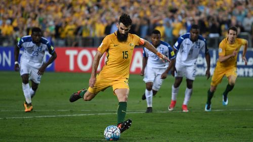 Mile Jedinak takes a penalty kick and scores his second goal. (AAP)