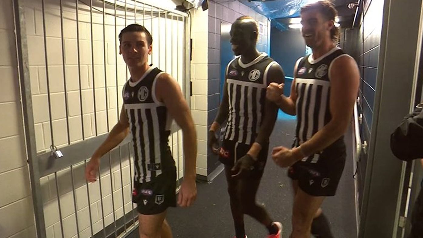 Port Adelaide players change into forbidden prison bar jumper after Showdown victory