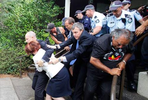 Julia Gillard escapes the furious mob, after being attacked at a function. (AAP)