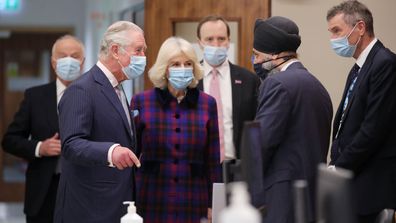  Prince Charles, Prince of Wales and Camilla, Duchess of Cornwall talk with with Chief Pharmacist Inderjit Singh as Health Secretary Matt Hancock looks on during a visit to The Queen Elizabeth Hospital on February 17, 2021 in Birmingham, England.