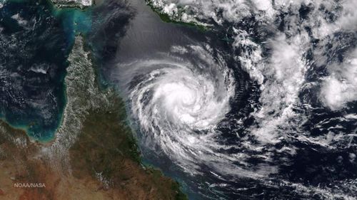 Authorities warn Queensland could be battered by category five cyclone as Nathan builds up speed