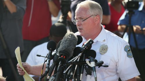 Standing in the parking lot of a gas station which was burned during rioting, Ferguson Police Chief Thomas Jackson addresses the crowd. (Getty Images)