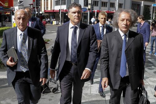 Dreamworld CEO Craig Davidson (centre) arrives with lawyers to the pre-inquest hearing into the fatal accident at the Dreamworld theme park, at the Brisbane Coroners Court in Brisbane, Tuesday, April 3, 2018. 