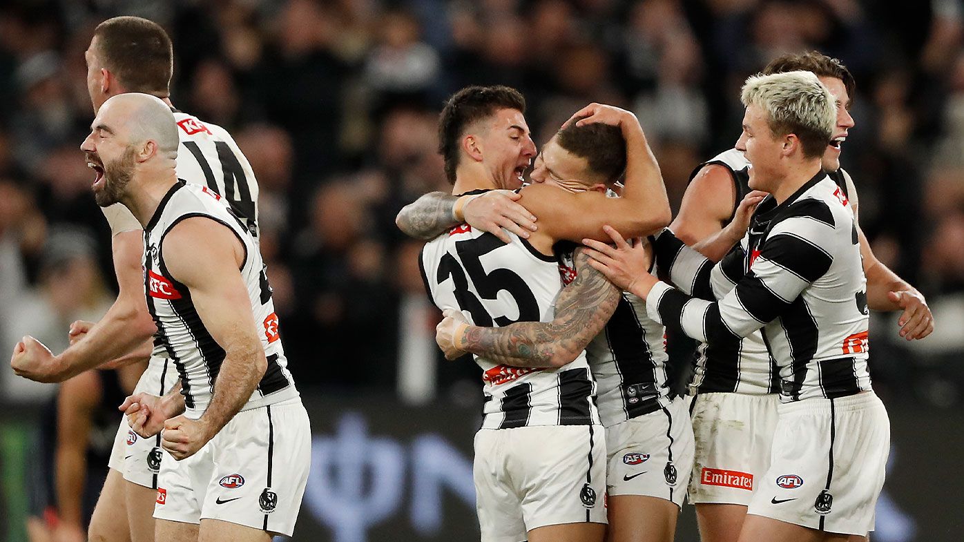 Collingwood players celebrate at the final siren after the win over Carlton