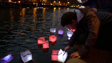 Floating lanterns are placed on the Canal St Martin to commemorates the anniversary of the Paris terrorist attacks. (AFP)