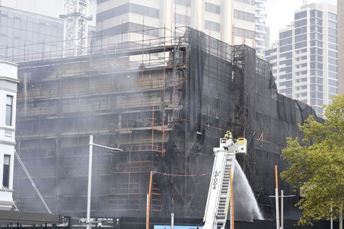 The blaze at the 10-storey building is now contained after a sheet of scaffolding caught fire and collapsed. (AAP)