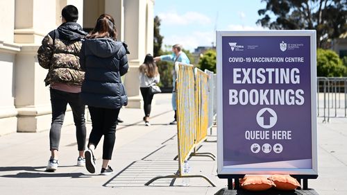 MELBOURNE, AUSTRALIA - OCTOBER 12: People enter the Vaccination Centre at Royal Exhibition Building in Carlton on October 12, 2021 in Melbourne, Australia. Victoria has recorded 1466 new COVID-19 cases and eight deaths in the last 24 hours. The state will reach a vaccination milestone today, with 60% of Victorians over the age of 15 having received two doses of a COVID-19 vaccine. (Photo by Quinn Rooney/Getty Images)