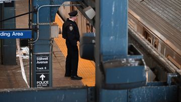 Police investigate at the Coney Island-Stillwell Avenue Station in Brooklyn after a woman aboard a subway car was set on fire and died in New York on Sunday.