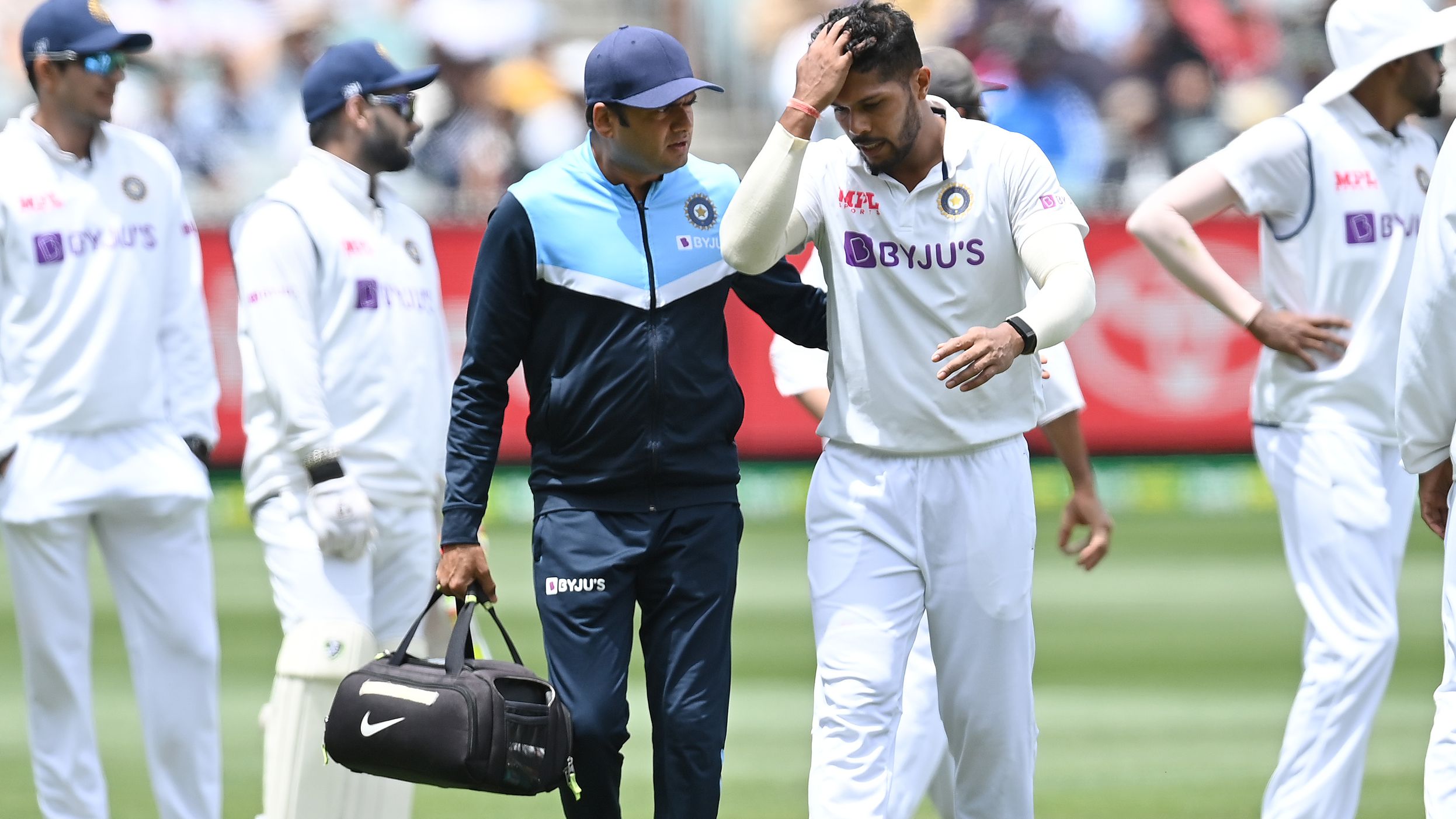 Umesh Yadav of India leaves the field injured at Melbourne Cricket Ground.