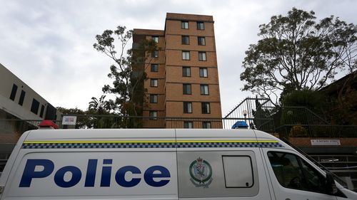  NSW police monitor an apartment block in Botany Street in Bondi after multiple cases.