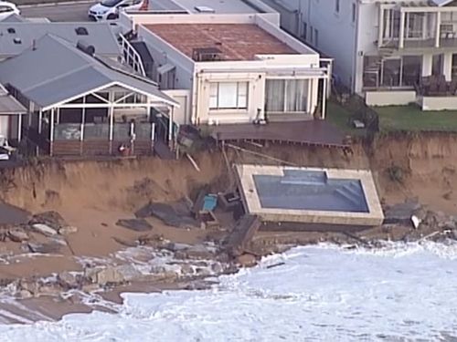 A pool slides onto the beach at Collaroy as massive swells erode the beach. (9NEWS choppercam)