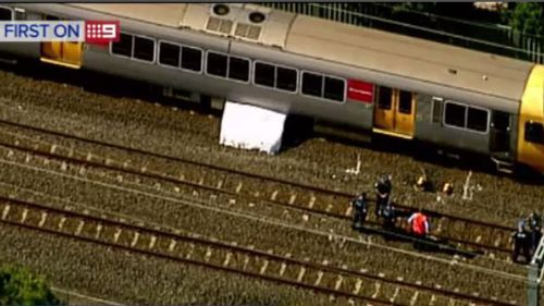 CCTV footage captured the man trainsurfing and attempting to graffiti the back of a train near Runcorn. (9NEWS)