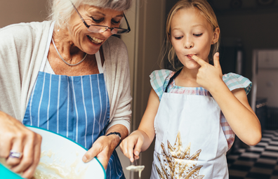 Grandmother with young girl cooking
