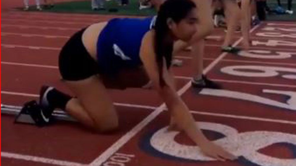 Young athlete masters reverse cartwheel as part of pre-race routine